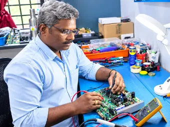 Electronics technician repairing a circuit board